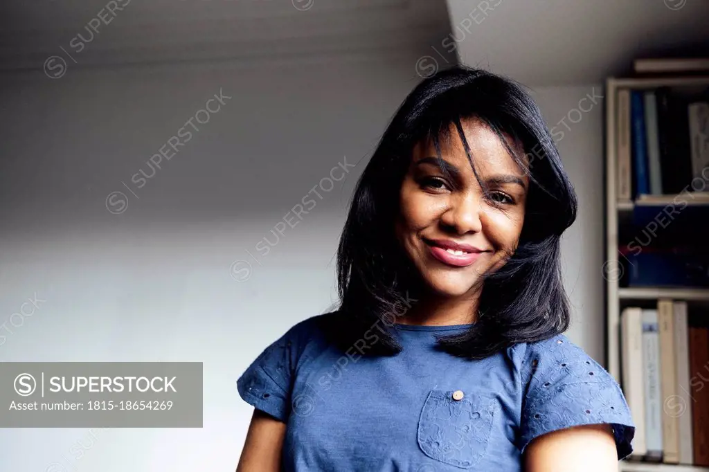 Beautiful smiling woman with black hair at home