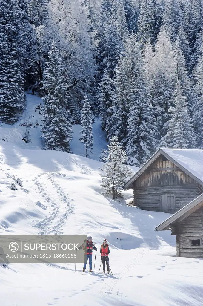 Mid adult couple standing on snow in winter