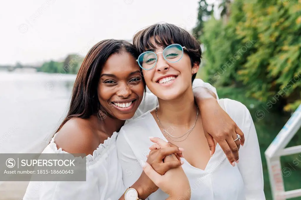 Cheerful female friends at lakeshore