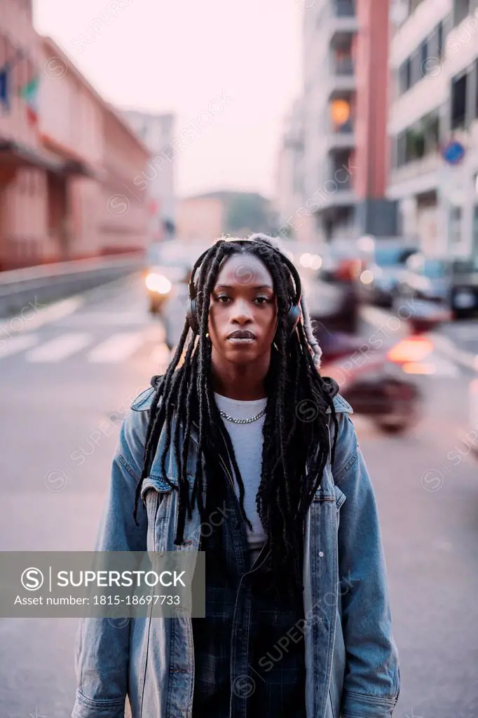 Young woman with blank expression on road