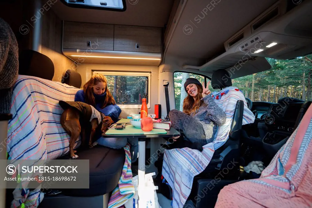 Friends having breakfast in camper van