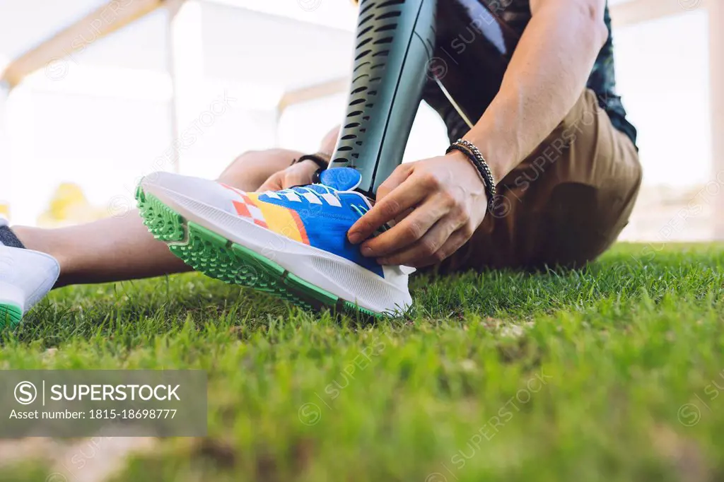 Man with amputed leg wearing shoes on grass