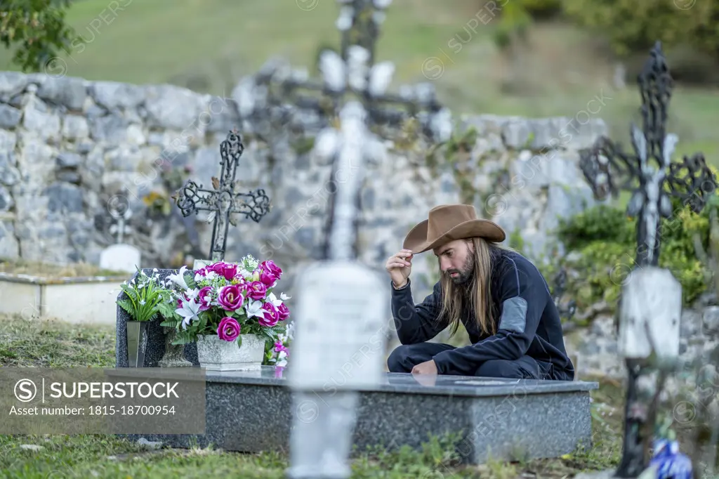 Man wearing hat at cemetery