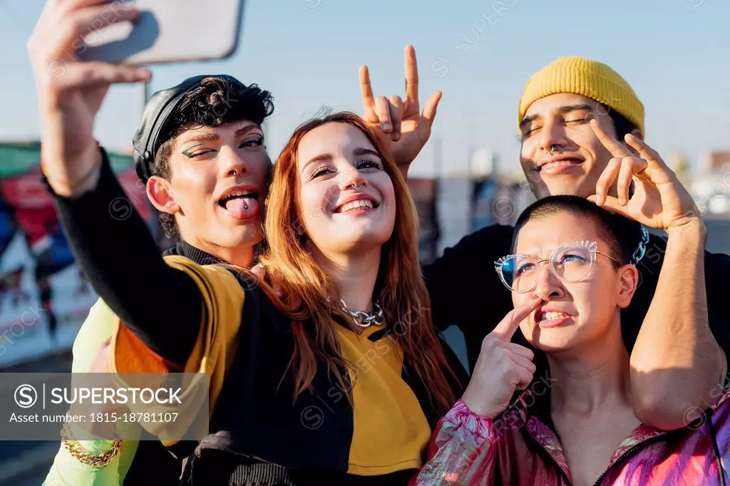 Friends taking selfie through smart phone on sunny day