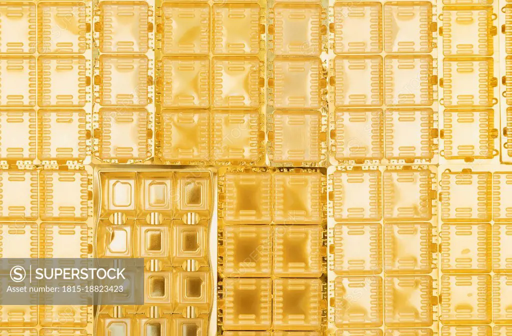 Full frame of gold colored plastic packaging