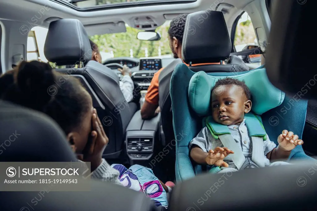 Family in car on road trip