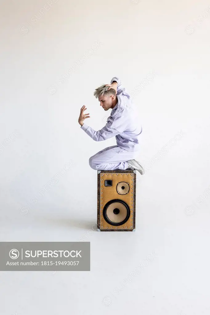 Young man on speaker against white background