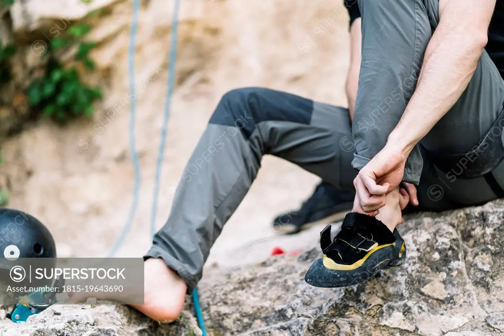 Man wearing boot before going for rock climbing