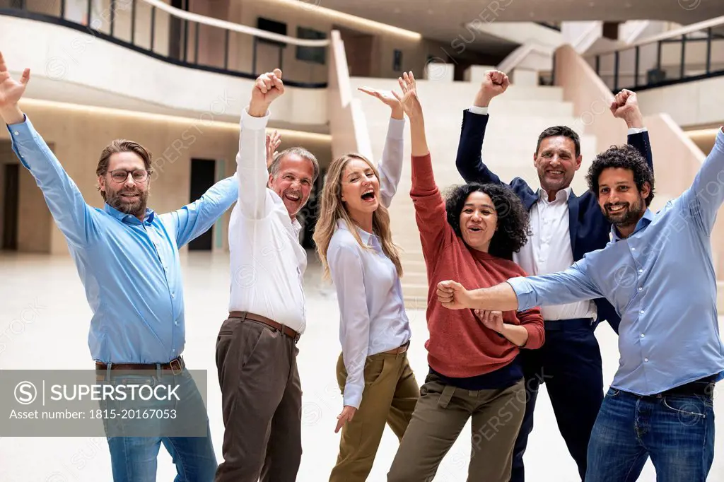 Carefree business colleagues dancing in lobby