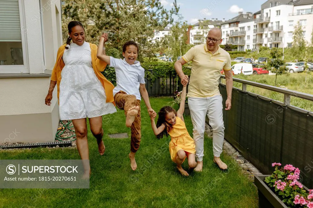 Happy parents with children enjoying in garden