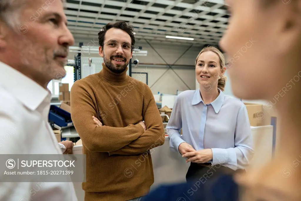 Smiling business colleagues discussing at industry