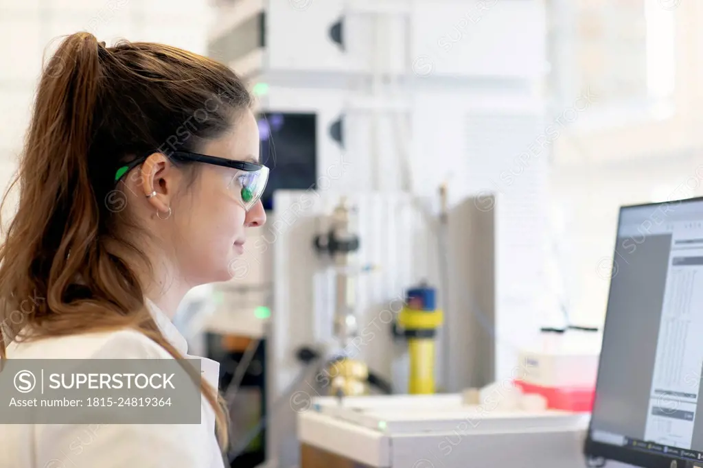 Scientist analyzing medical test results on computer in laboratory