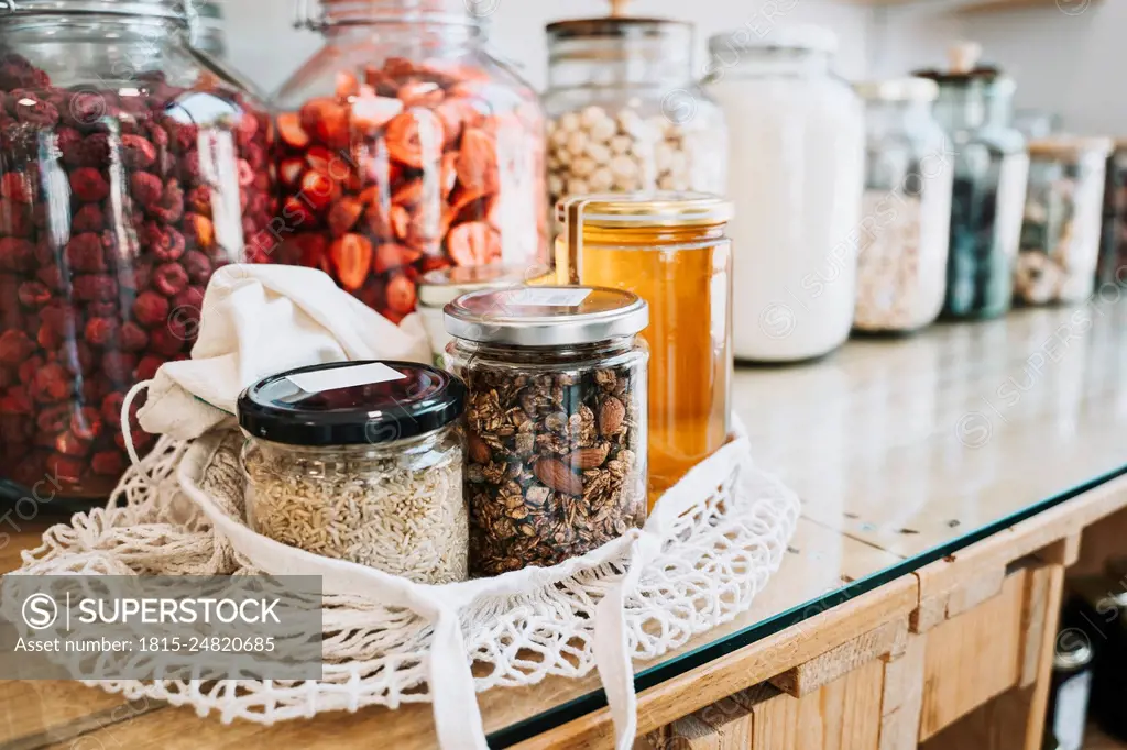 Raw food in mason jars on table at sustainable store