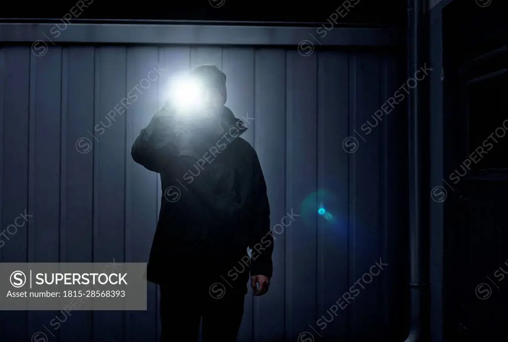 Watchman searching site with torchlight