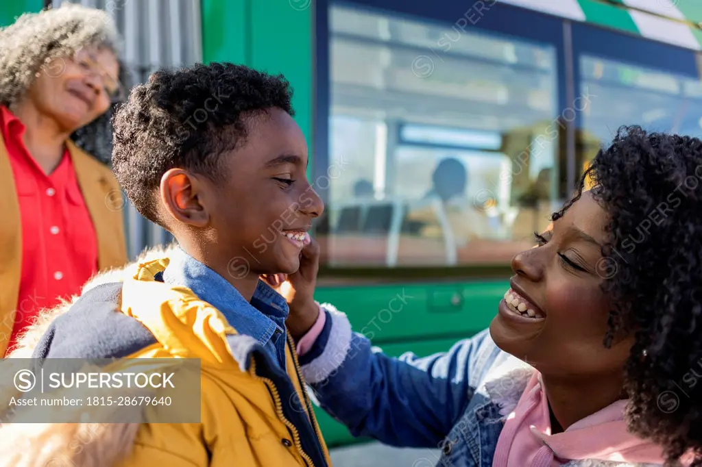 Happy multi-generation family at railroad station