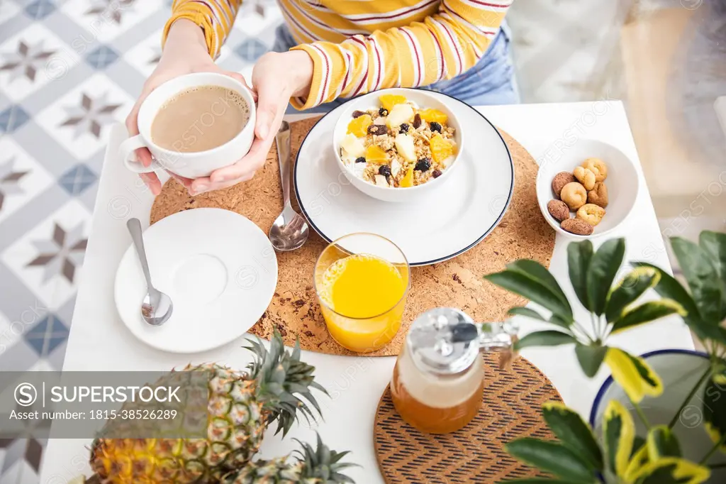 Woman having healthy breakfast at table