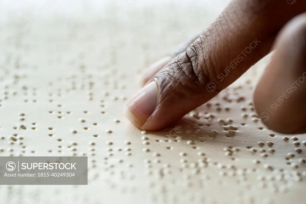 Woman reading braille text from book