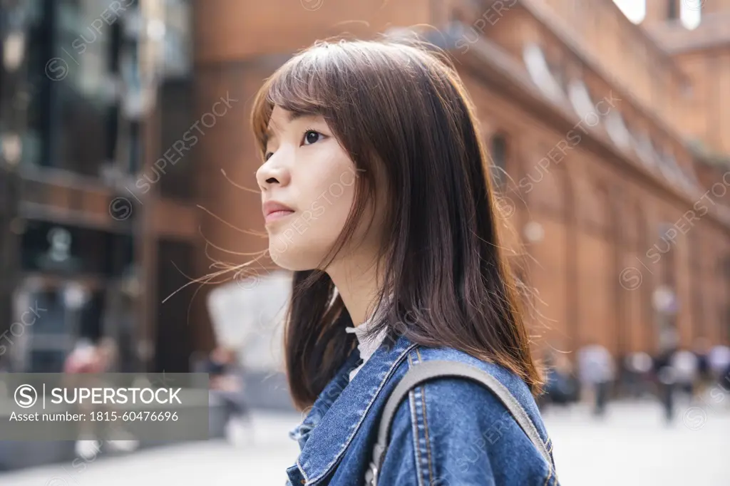 Young woman in front of building at street