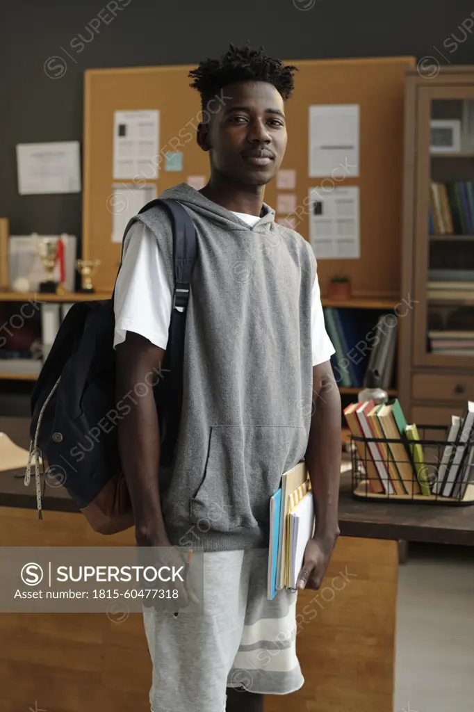 Student standing with backpack in university office