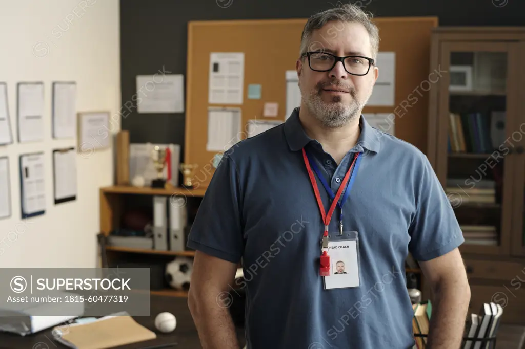 Coach wearing ID card and whistle in university office