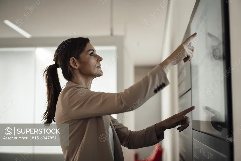 Businesswoman using digital screen and working at office