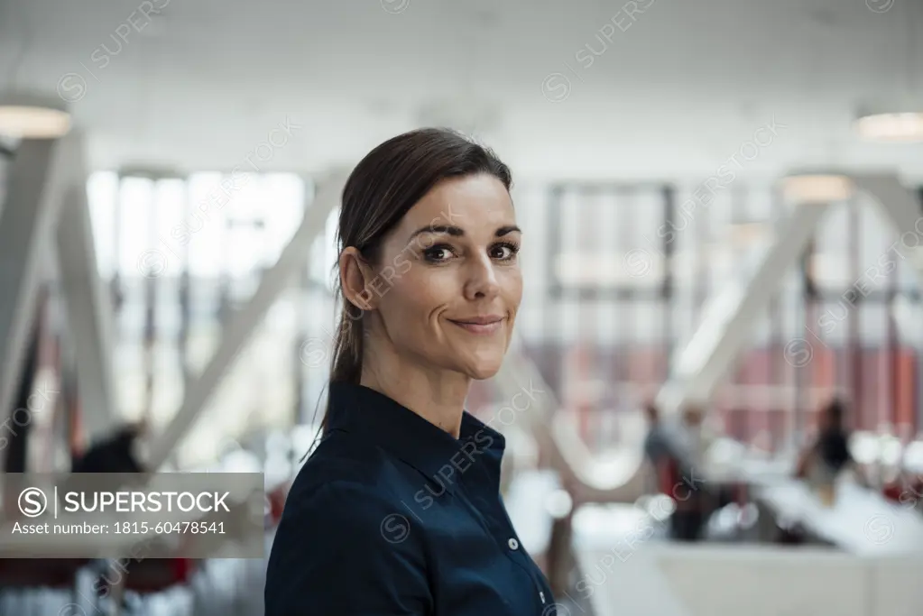 Smiling businesswoman standing at airport lobby