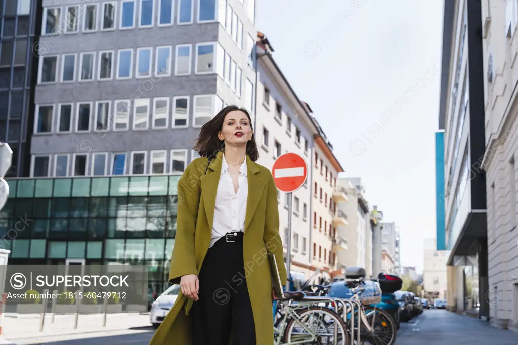 Fashionable businesswoman walking in city