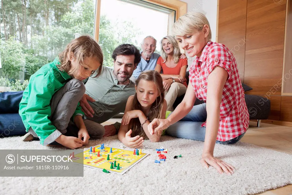 Germany, Bavaria, Nuremberg, Family playing board game together