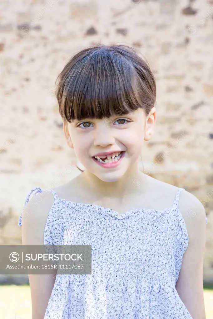 Portrait of smiling little girl with tooth gap