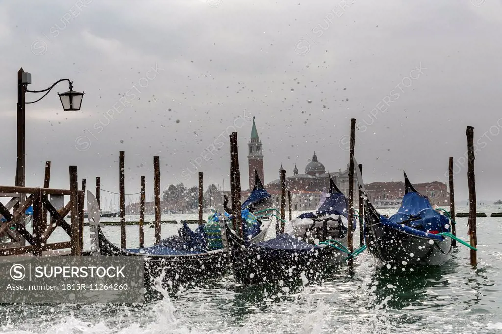 Italy, Venice, Gondolas and church San Giorgio Maggiore at high watermark