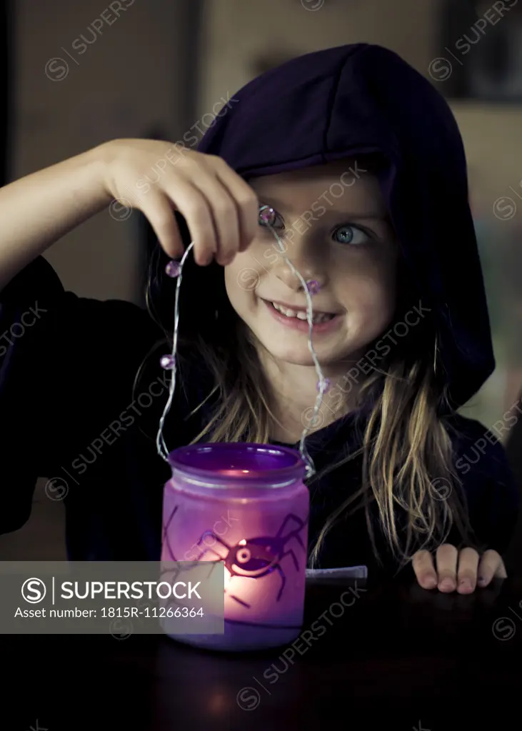 Portrait of little girl holding Halloween latern