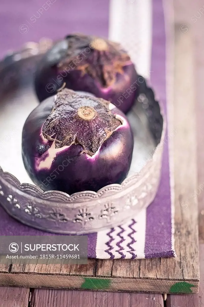 Two eggplants, Solanum melongena, on a tray