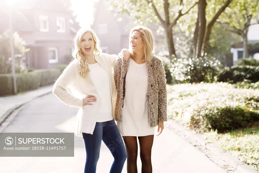 Two smiling blond women having fun together