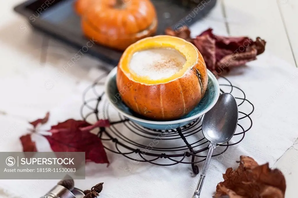 Oven baked mini-pumpkin filled with spiced hot coconut cream