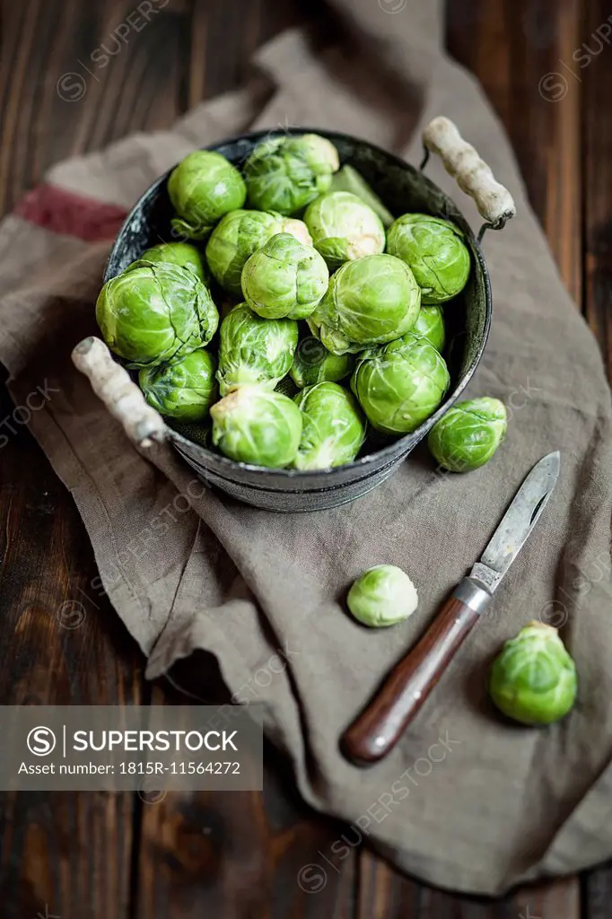 Peeled brussel sprouts in tin bucket, knife, studio