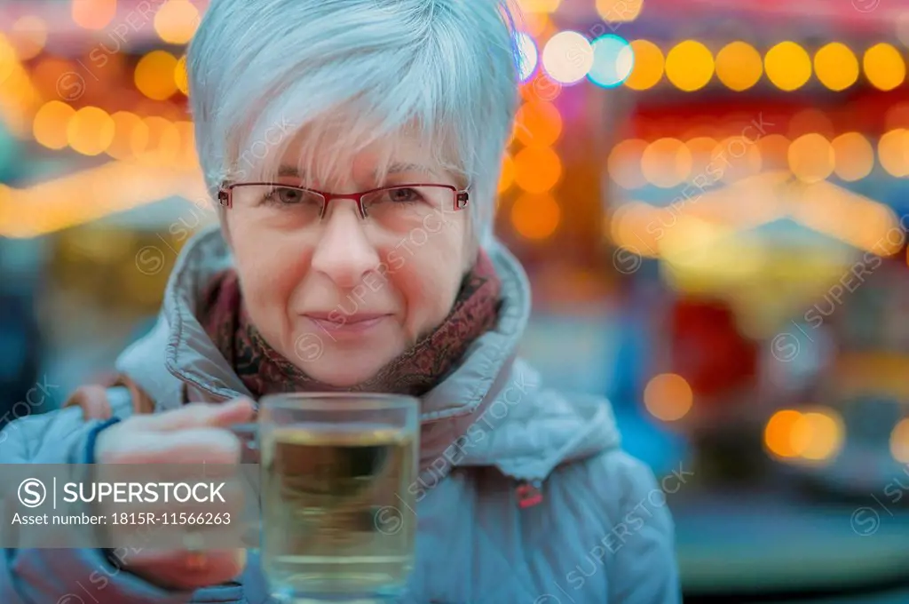 Senior woman holding glass of mulled wine