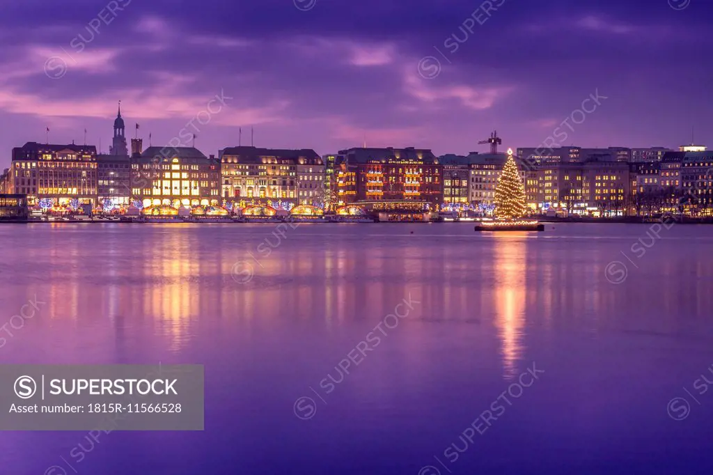 Germany, Hamburg, Downtown skyline with illuminated Christmas tree on Alster river