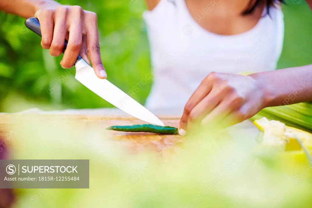 Young woman preparing healthy meal in garden