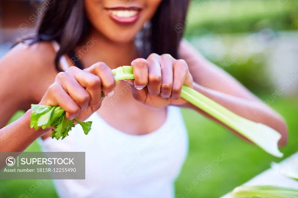 Young woman preparing healthy meal in garden