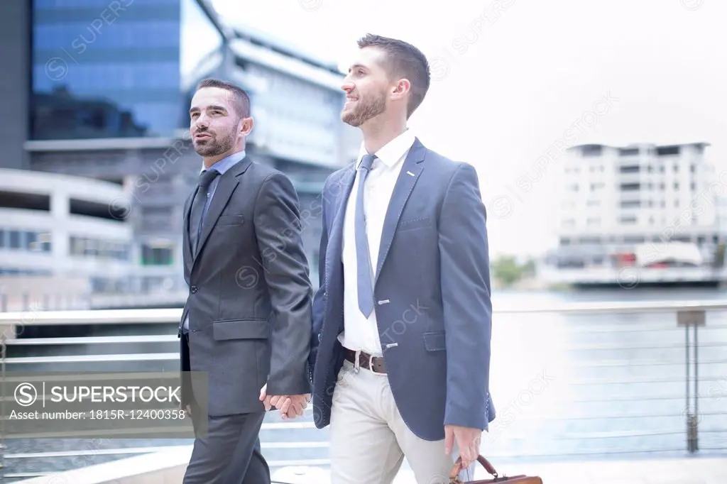 Gay couple walking with business suits