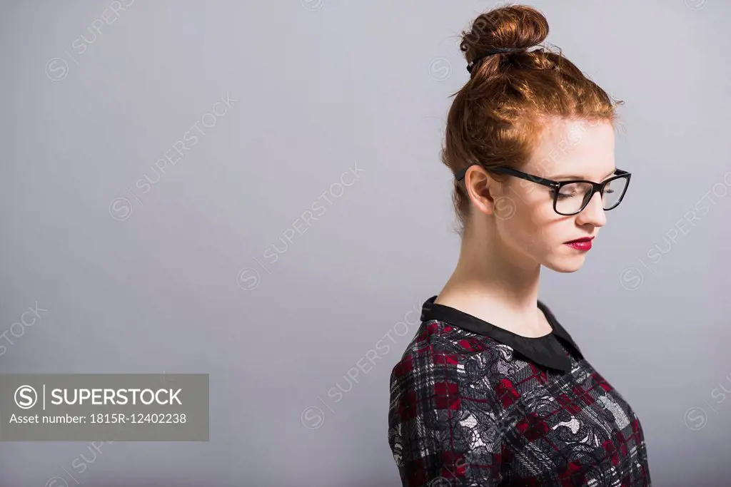 Young woman with glasses and bun