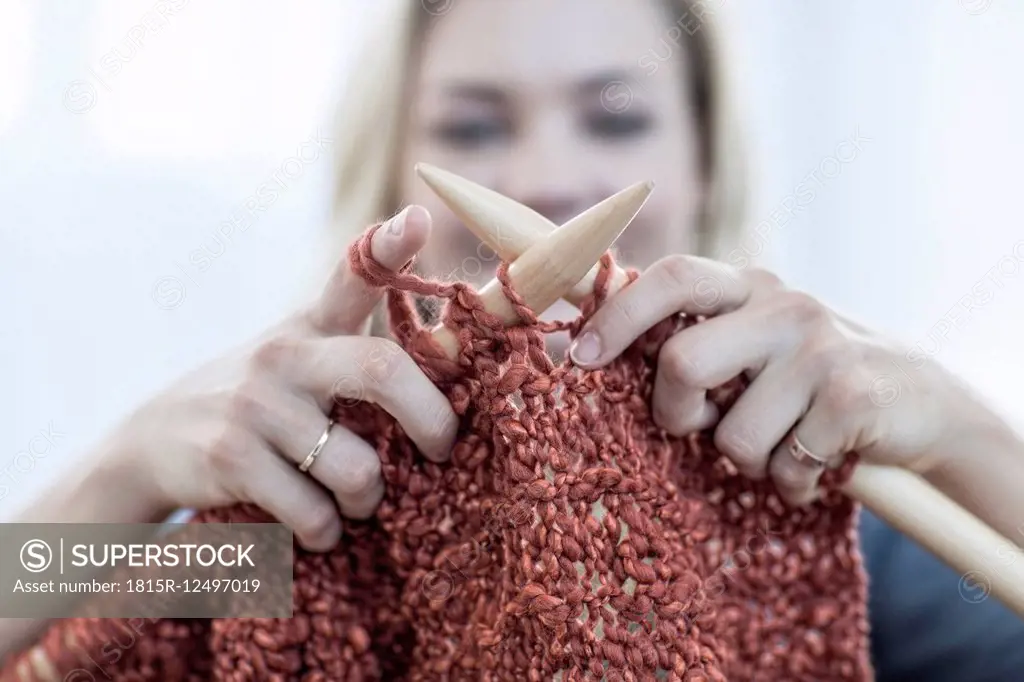 Close-up of woman knitting a blanket