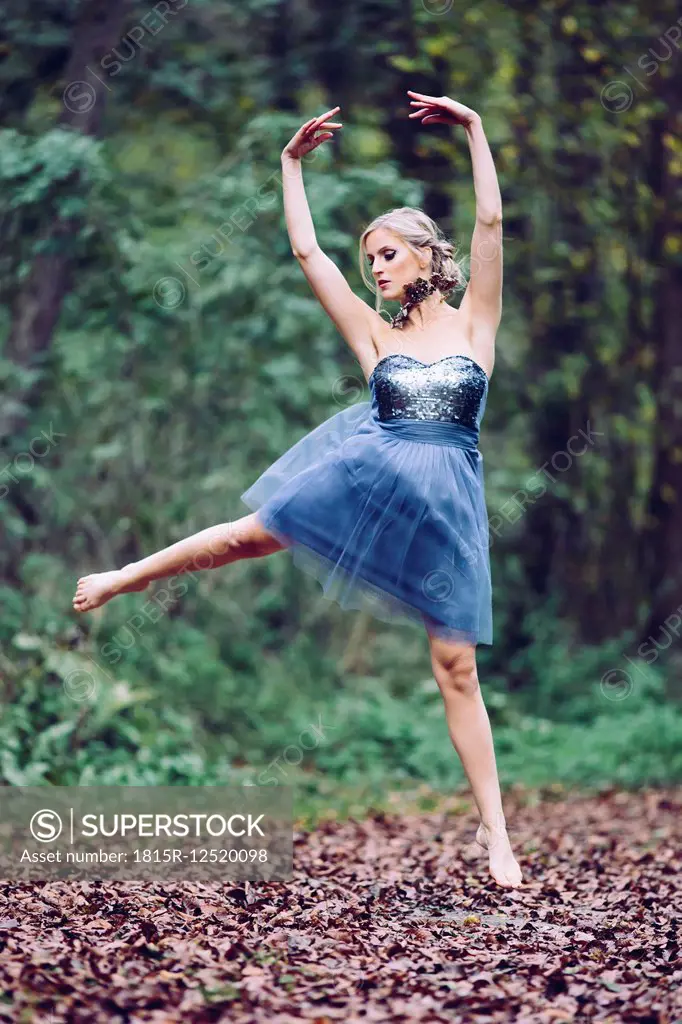 Austria, female dancer in the wood, jumping