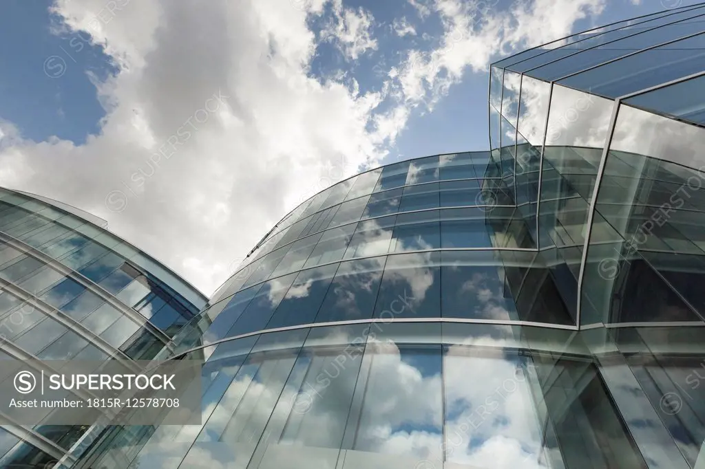 Switzerland, Geneva, glass facade of modern office building with reflections of clouds