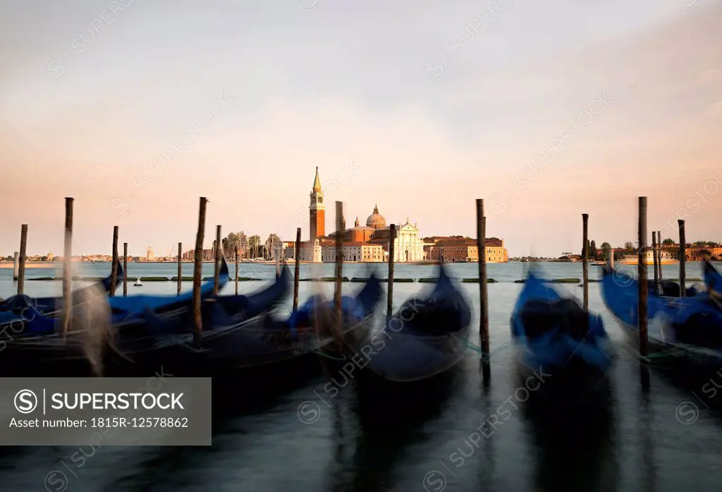 Italy, Venice, gondolas in front of San Giorgio Maggiore at dusk