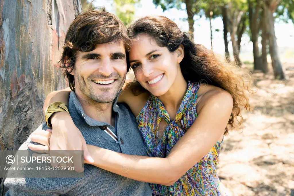 South Africa, happy couple embracing at a tree