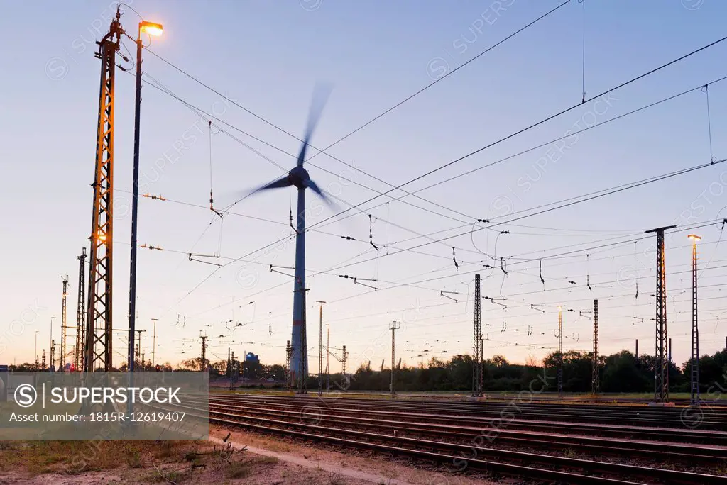 Germany, Hamburg, railway track with catenary and wind turbine
