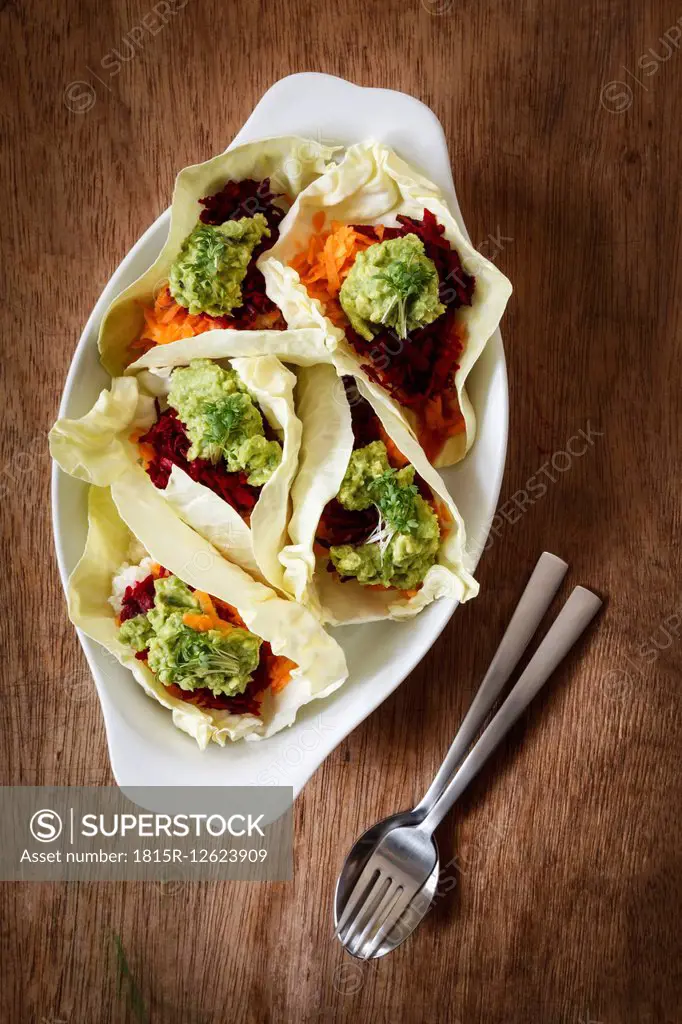 Grated vegetables, cauliflower, carrott, betroot with avocado dip in sweetheart cabbage leaves