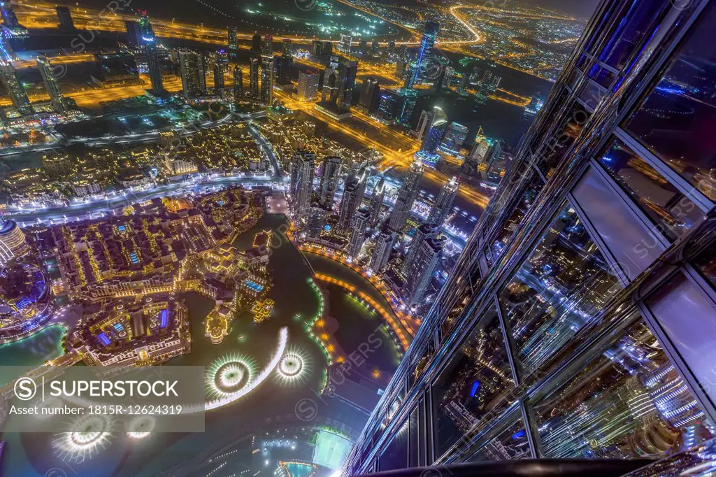 United Arab Emirates, Dubai, Fountain in the Burj Khalifa Lake with Souk Al Bahar seen from the Burj Khalifa at night