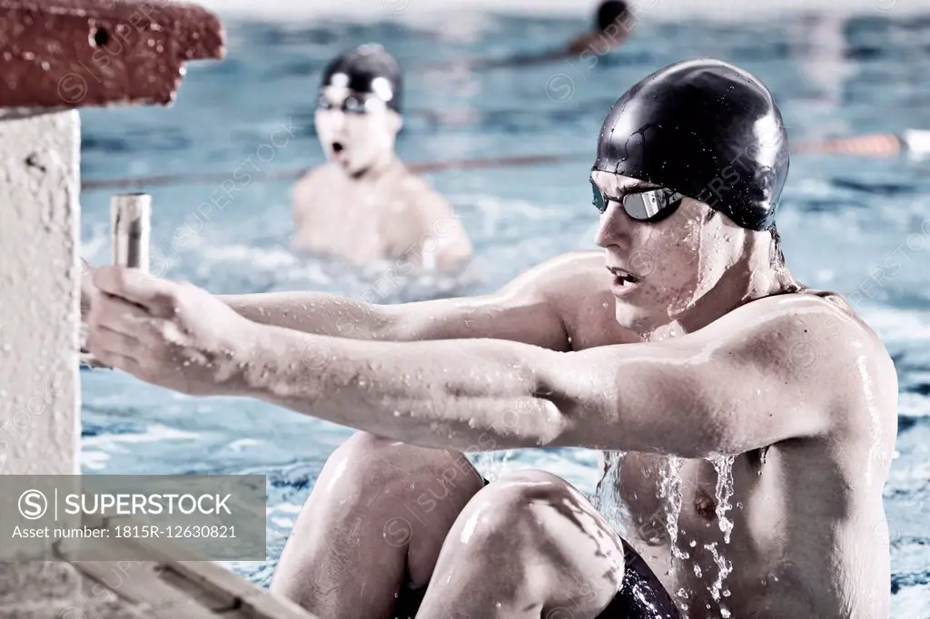 Backstroke swimmer in indoor pool in starting position